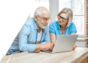 A man and woman looking at a computer together